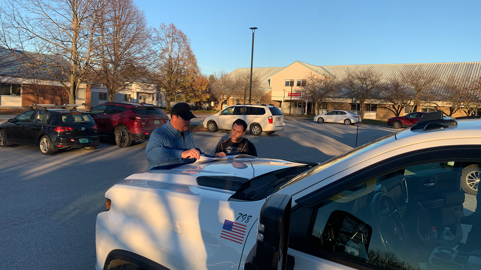 Velco employees discussing work near a work truck