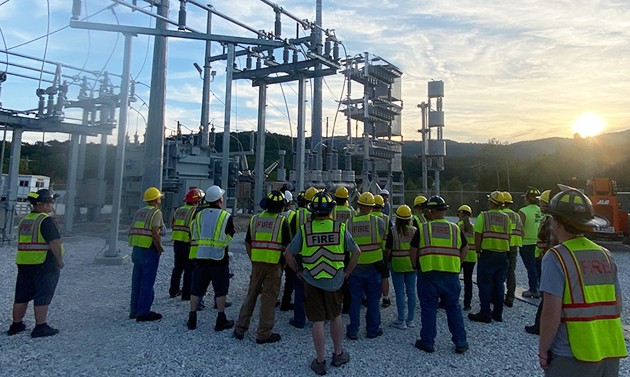 VELCO workers gather near power station at sunrise