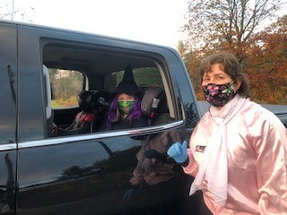 Velco worker with mask on collecting food donations