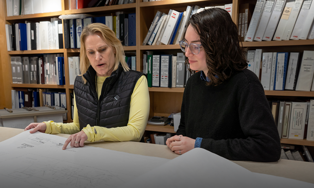 Tina and Arianne looking at drawings in VELCO library 