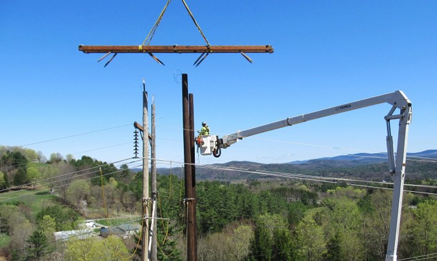 VELCO workers on power line pole