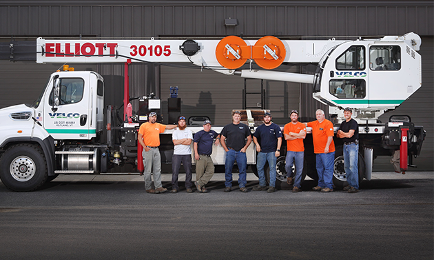 Picture of people in front of a truck.